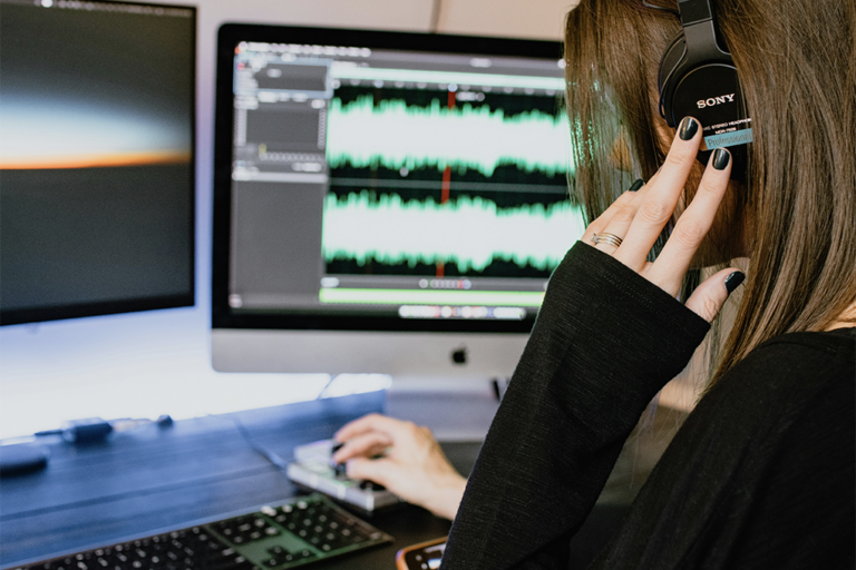 Women listening to a recording through a audio editing software