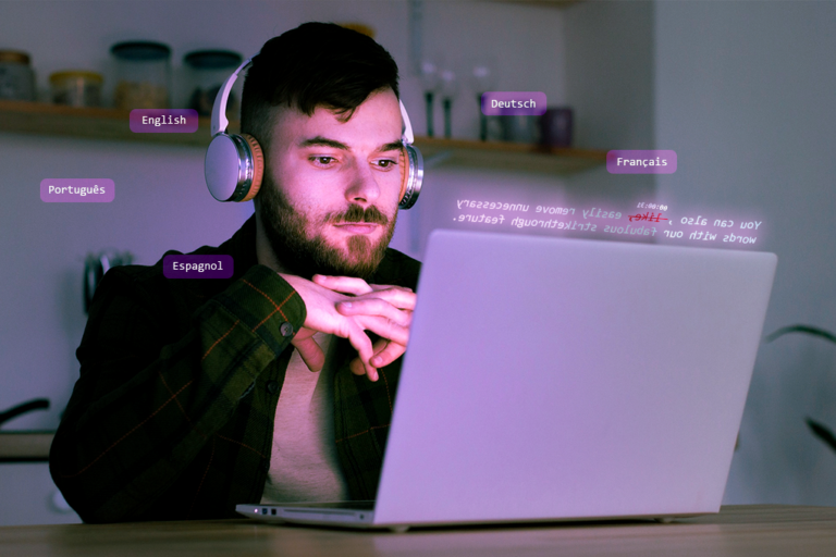A man wearing a headphone looking at a laptop
