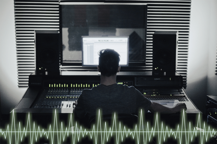 A man doing a transcription job while sitting in front of a big screen