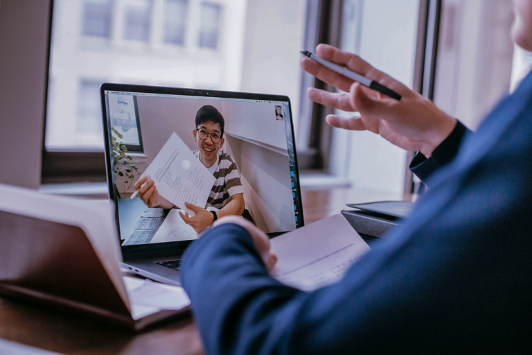 a student on a video call reviewing a text