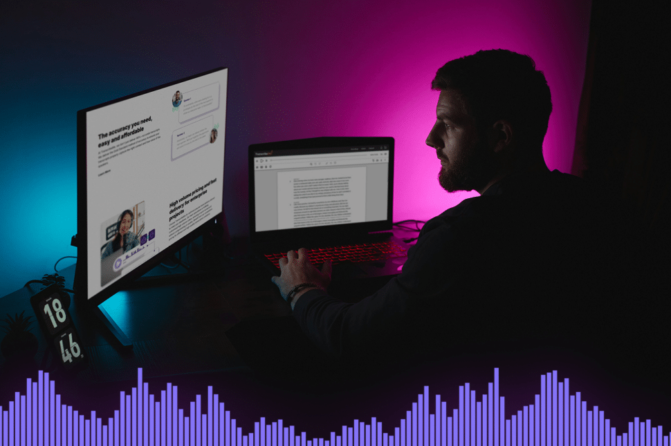 man looking at two screens and reading two big blocks of text