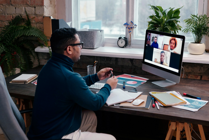 team on a virtual call with multiple faces on screen