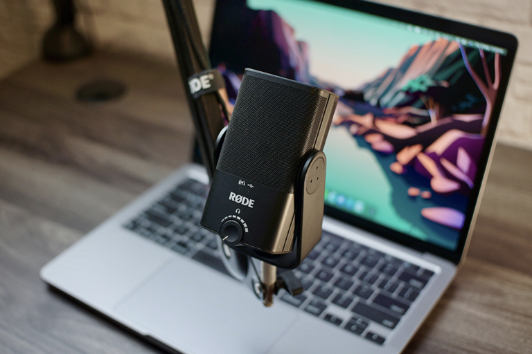 micrófono colgante frente a un portátil mac