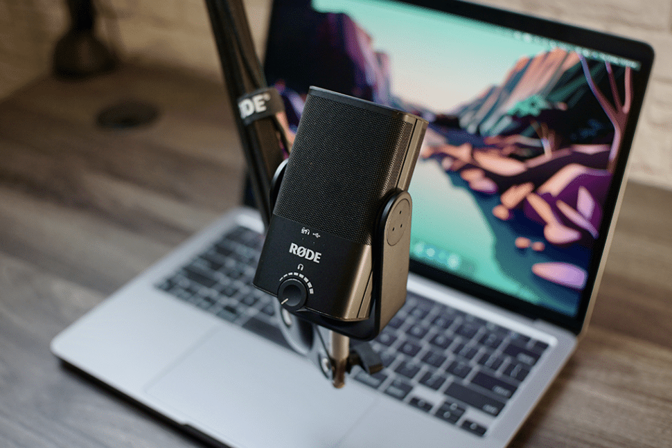 висячий микрофон, стоящий перед ноутбуком mac